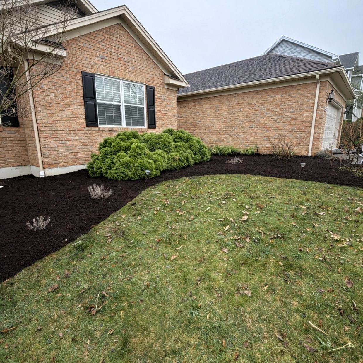 Front beds mulched at a brick home