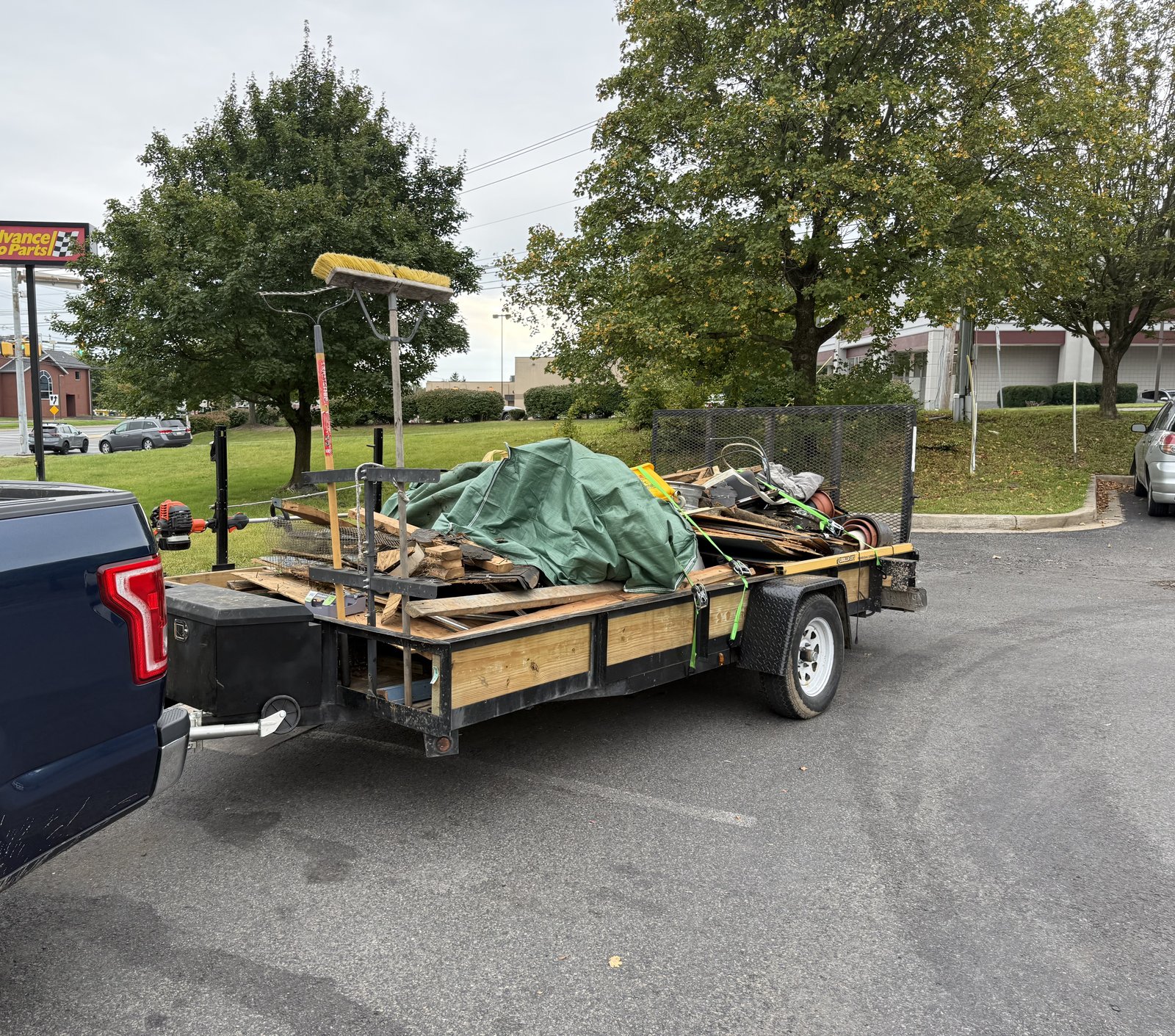 MB Landscaping hauling trailer loaded with junk