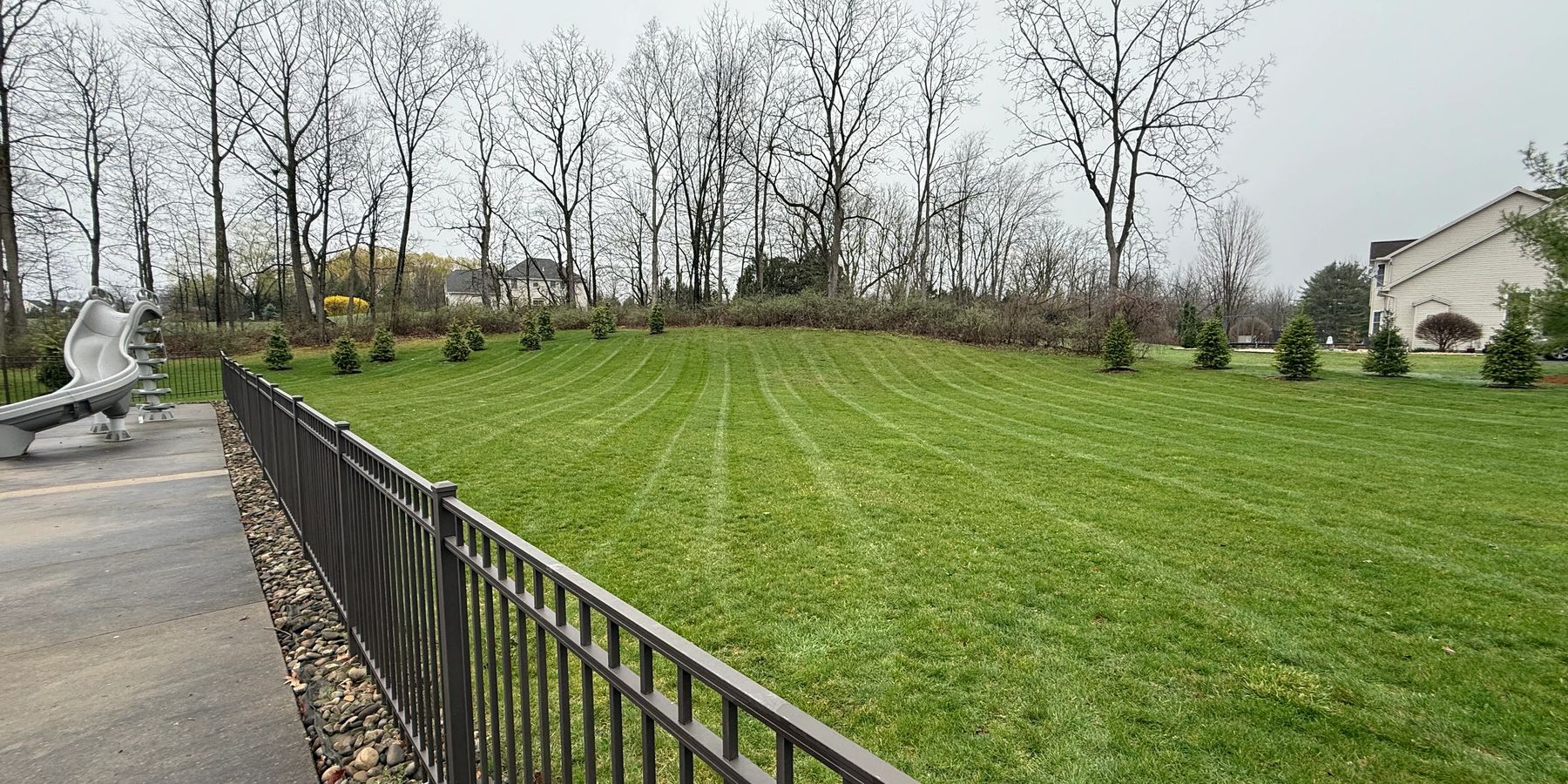 Fresh dark mulch along a home foundation